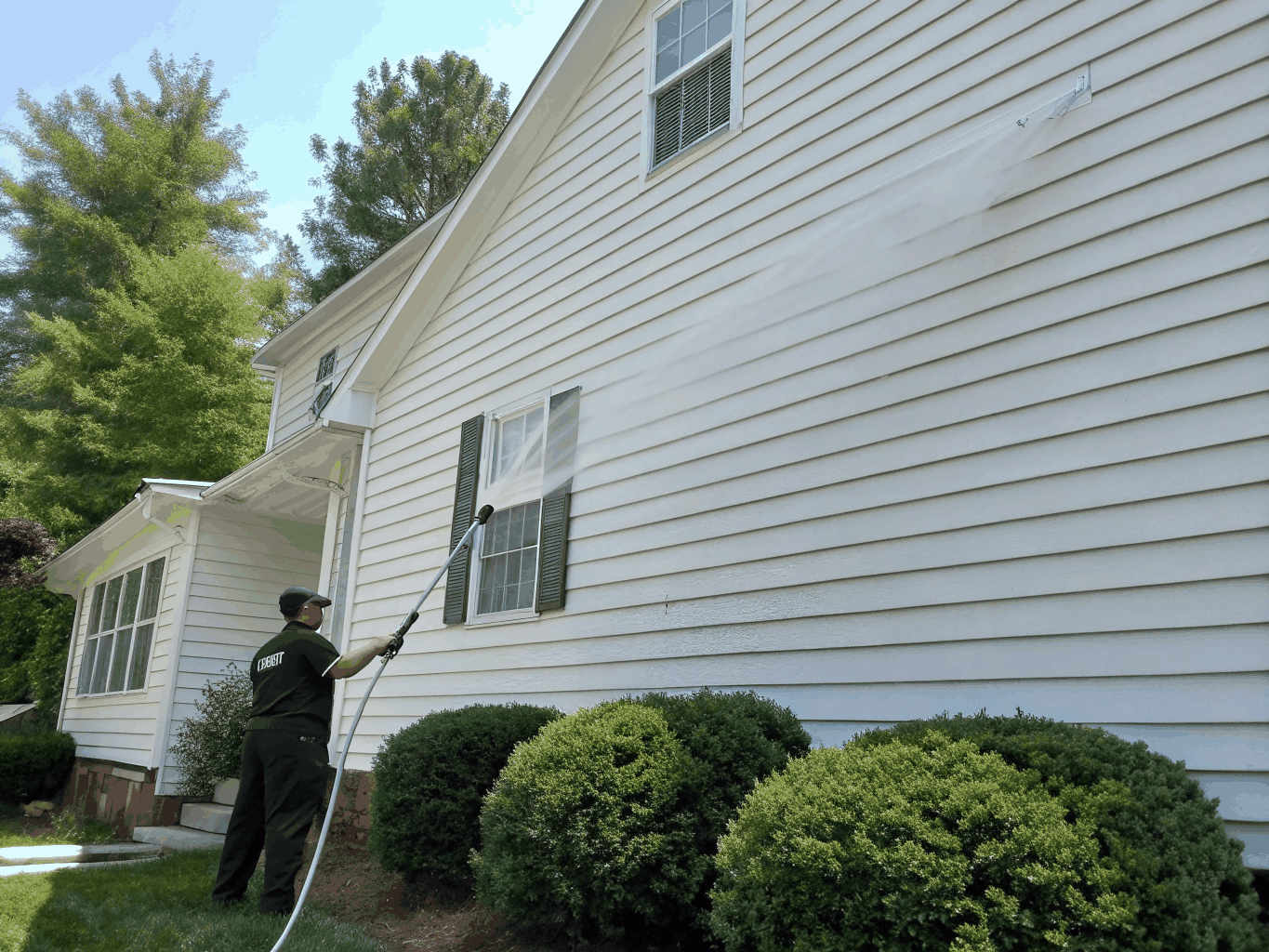 Vinyl siding being soft washed
